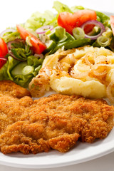 Fried pork chop with potatoes and vegetable salad