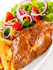 Grilled meat, French fries and vegetables
