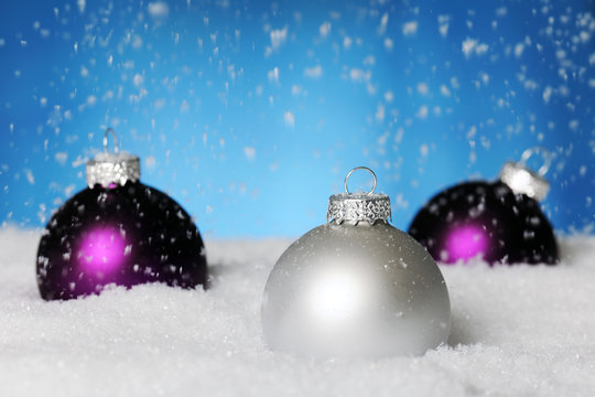 three baubles on the snow
