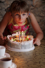 Girl is blowing on candle