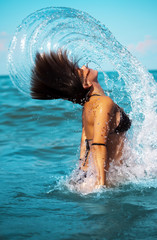 splashes. Girl in the sea