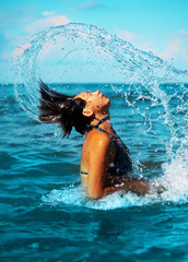 splashes. Girl in the sea