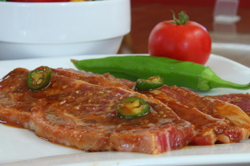 Short Ribs on a plate with a pepper and tomato garnish