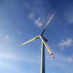 Wind turbine under blue sky