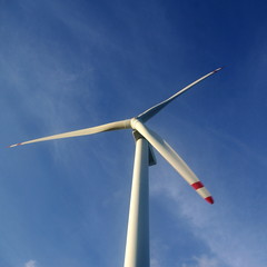 Wind turbine under blue sky