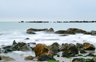 Fototapeta na wymiar Long exposure rocky beach