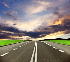 Asphalt road and sunset sky