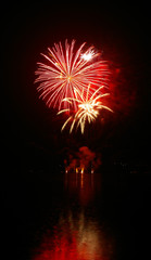 Fototapeta na wymiar Colorful fireworks with water reflection