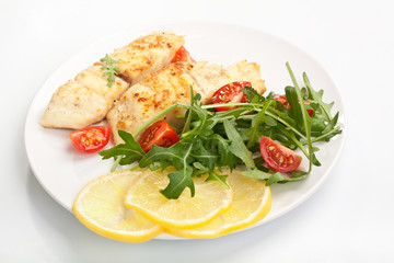 white fish with vegetables and lemon