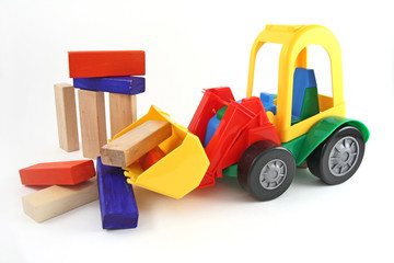 Plastic toy, excavator and wooden blocks