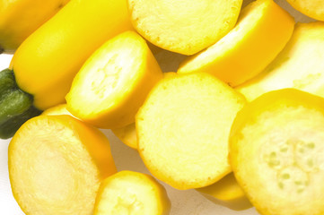 two yellow zucchini squash with slices