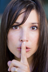 Fototapeta premium teenage girl with finger on lips