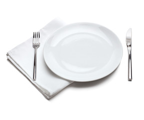 White empty plate with fork and knife