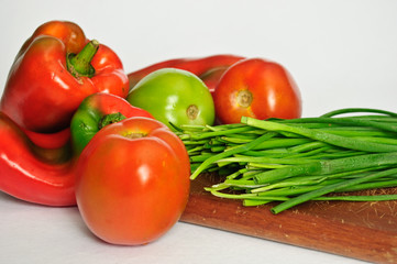 tomatoes peppers and scallions in table