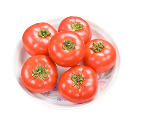 Red fresh tomatoes in dish
