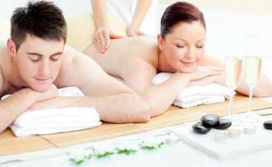 Obraz na płótnie Canvas Charming young couple enjoying a back massage