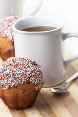 Tasty muffins with cup of tea