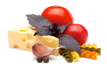 Tomatoes, colorful fancy fusilli, spices, garlic, basil