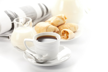 Cup of fragrant coffee on a morning paper business news