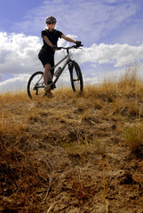 Fototapeta na wymiar Young Woman Mountain Biking