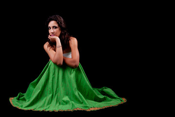 Fototapeta premium young and beautiful woman seated and pensive