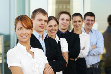 A group of six young business persons standing in a row