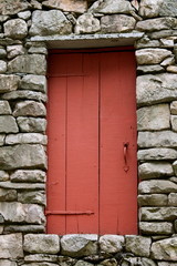 red door in stone house