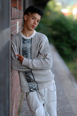Teenage Boy leaning on a wall