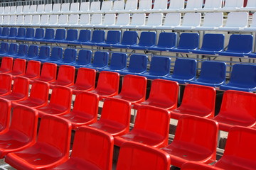 Naklejka premium Rows of red, blue and white plastic chairs