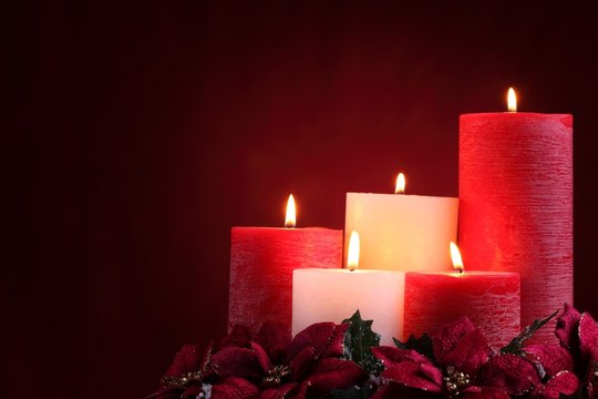 Burning candles with seasonal decorations