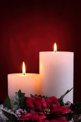 Burning candles with seasonal decorations