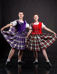 Two girls dancing the Scottish dance in a kilt