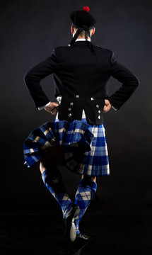 The Young Man Dancing The Scottish Dance In A Kilt