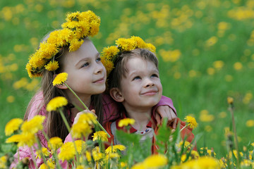 Brother and sister with dandelion garlands