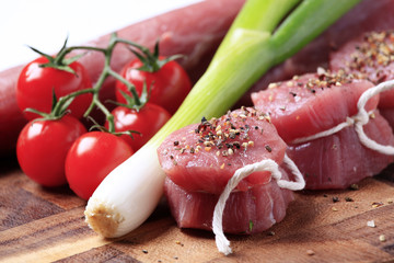 Raw pork tenderloin and vegetables
