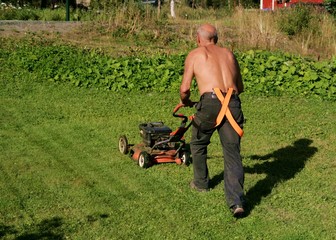 Senior mowing a lawn