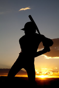 Silhouette baseball ready to swing sunset