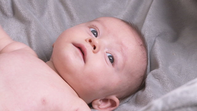 Portrait  of three month old baby laying on back