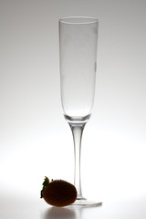 wine glass and strawberries on a gray background