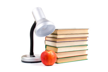 Table lamp, apple and books