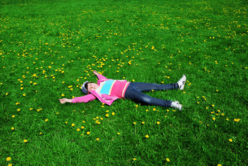 resting child on green grass meadow