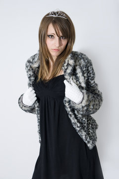 Fashionable teenager girl in fur coat