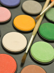 watercolor paints and paint brush