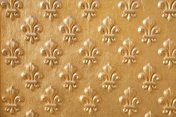 Goldened fleur de lys seamless pattern