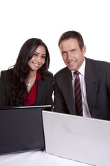 Man and woman looking over laptops