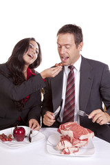 Couple eating her feeding him