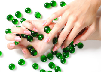 Beautiful hands with perfect nail pink manicure and green decora