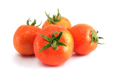 Four tomatoes with water drops isolated on a white with a shadow