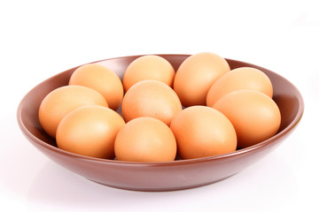 Group of brown hen's eggs in the flat plate isolated on white