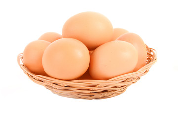Group of brown hen's eggs in the braided backet isolated in whit